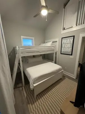 a bedroom with a bunk bed with a play for supreme sign at Barefoot Dreams! in Panama City Beach
