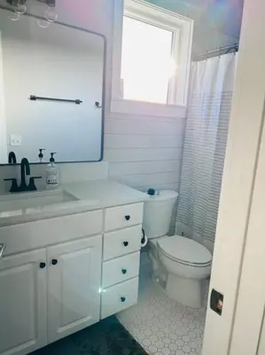 a bathroom with a toilet and a sink and a mirror at Barefoot Dreams! in Panama City Beach