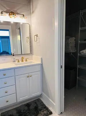 a bathroom with a sink and a mirror at Barefoot Dreams! in Panama City Beach