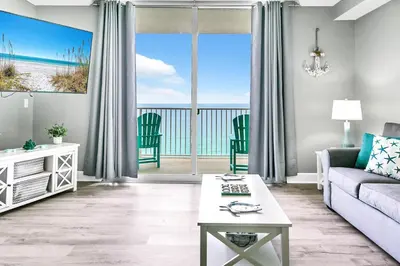 a living room with a couch and a view of the ocean at Tidewater 2308 by Emerald Coast Retreats in Panama City Beach