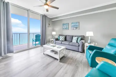 a living room with a couch and a table at Tidewater 2308 by Emerald Coast Retreats in Panama City Beach