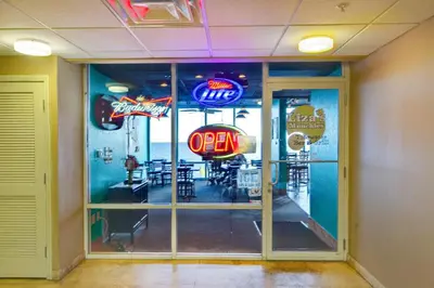 a restaurant with a open sign in the window at Tidewater 2308 by Emerald Coast Retreats in Panama City Beach