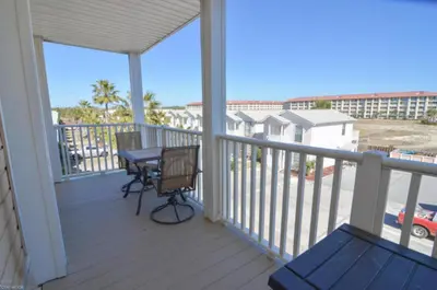 a balcony with a table and chairs on it at Beach Place Seconds to Beach 6 in Panama City Beach