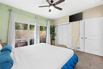 a bedroom with a white bed and a window at Beach House - Sea La Vie by Panhandle Getaways in Panama City Beach