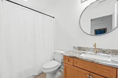 a bathroom with a toilet and a sink and a mirror at Beach House - Sea La Vie by Panhandle Getaways in Panama City Beach