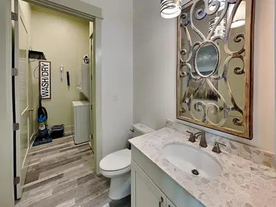 a bathroom with a toilet and a sink and a mirror at Resting Beach Face in Panama City Beach