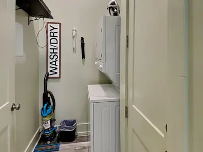 a room with a cabinet and a door with aiger at Resting Beach Face in Panama City Beach