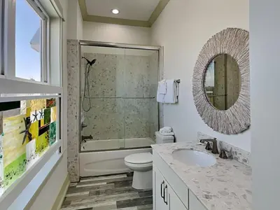 a bathroom with a shower and a toilet and a sink at Resting Beach Face in Panama City Beach
