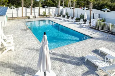 a white umbrella next to a swimming pool at Salty Sons 4 BR and just minutes to the Beach Rosemary and 30Avenue in Inlet Beach