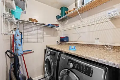 a laundry room with a washing machine in it at Gulf Highlands 146 by Book That Condo in Panama City Beach