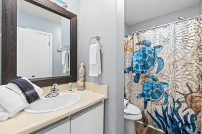 a bathroom with a sink and a shower curtain at Gulf Highlands 146 by Book That Condo in Panama City Beach
