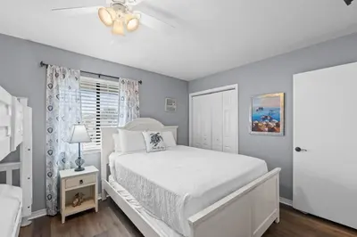 a bedroom with a white bed and a window at Gulf Highlands 146 by Book That Condo in Panama City Beach