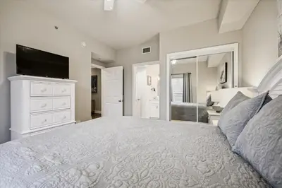 a bedroom with a large bed with a flat screen tv at Majestic Beach Resort 1411-1 by Book That Condo in Panama City Beach