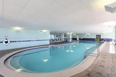 a large pool with blue water in a building at Majestic Beach Resort 1411-1 by Book That Condo in Panama City Beach