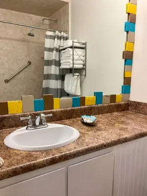 a bathroom counter with a sink and a shower at Beachfront Studio - Perfect Location - Free Beach Chairs in Panama City Beach