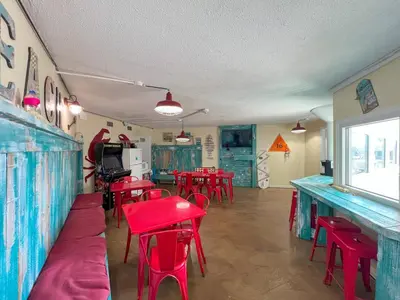 a dining room with red tables and red chairs at Beachfront Studio - Perfect Location - Free Beach Chairs in Panama City Beach
