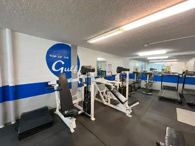 a gym with several tread machines in a room at Beachfront Studio - Perfect Location - Free Beach Chairs in Panama City Beach