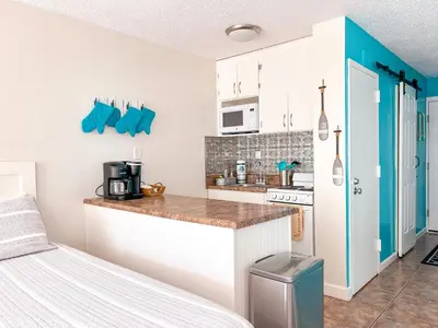 a kitchen with white cabinets and a counter top at Beachfront Studio - Perfect Location - Free Beach Chairs in Panama City Beach