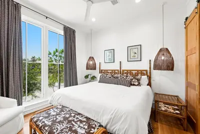 a bedroom with a bed and a large window at Salt & Light - 5 BR, Sleeps 18, Gulf & Lake Views, Game Room & Bikes in Seagrove Beach
