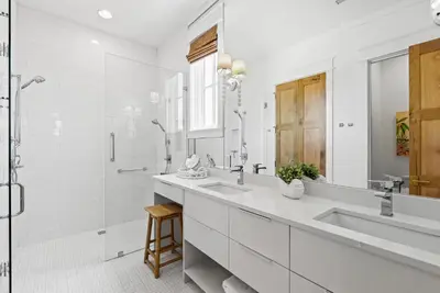 a white bathroom with two sinks and a shower at Salt & Light - 5 BR, Sleeps 18, Gulf & Lake Views, Game Room & Bikes in Seagrove Beach