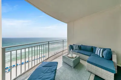 a balcony with a couch and a view of the ocean at Aqua Resort 906 by Emerald Coast Retreats in Panama City Beach