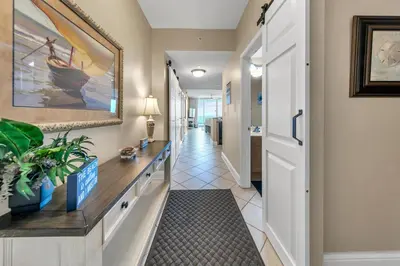 a corridor of a hallway with a hallway at Aqua Resort 906 by Emerald Coast Retreats in Panama City Beach