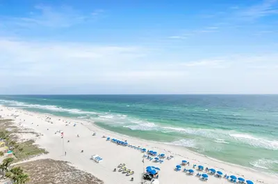 an overhead view of a beach with people and umbrellas at Aqua Resort 906 by Emerald Coast Retreats in Panama City Beach