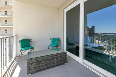 two chairs on a balcony with a view of the city at Laketown Wharf 1829 by Emerald Coast Retreats in Panama City Beach