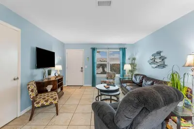 a living room with a couch and a tv at Beach Hideaway in Panama City Beach