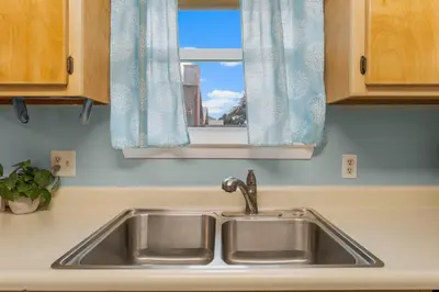 a sink in a kitchen with a window at Beach Hideaway in Panama City Beach