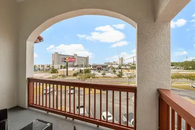 a balcony with a view of a city at The Inn At St Thomas Square #1305A in Panama City Beach