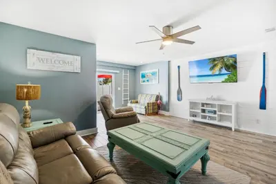 a living room with a couch and a table at Mimi's Beach Bungalow in Panama City Beach