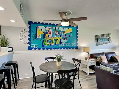 a living room with a table and a couch at Edgewater Villa #2012 in Panama City Beach