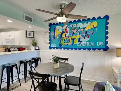 a dining room with a table and some chairs at Edgewater Villa #2012 in Panama City Beach