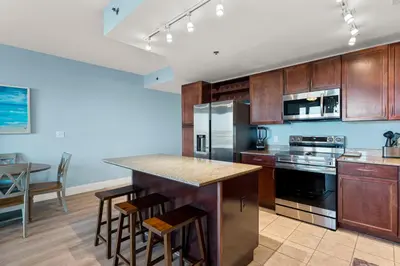 a kitchen with wooden cabinets and a counter top at Laketown Wharf #319 by Nautical Properties in Panama City Beach