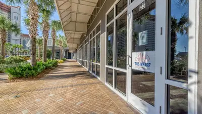 a hallway of a building with palm trees at Laketown Wharf #319 by Nautical Properties in Panama City Beach