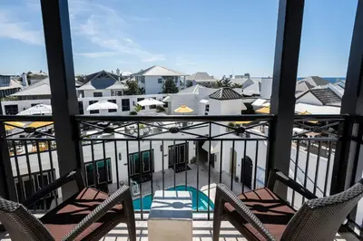 a view of a balcony with chairs and a pool at The Pearl Hotel in Rosemary Beach