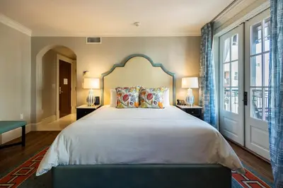 a bedroom with a large bed and a large window at The Pearl Hotel in Rosemary Beach