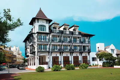 a large white building with a clock tower at The Pearl Hotel in Rosemary Beach