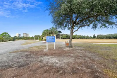a sign next to a tree on the side of a road at Moonspinner #715A By Book That Condo in Panama City Beach