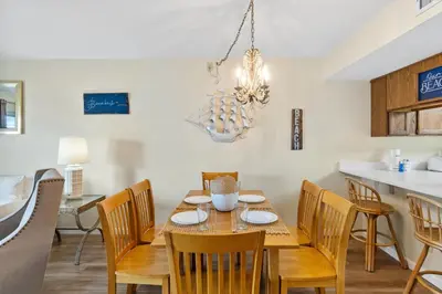 a dining room with a table and chairs at Moonspinner #715A By Book That Condo in Panama City Beach