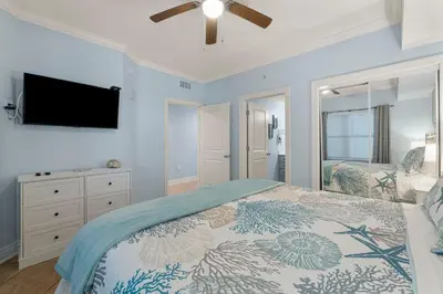 a bedroom with a bed and a flat screen tv at Palazzo #505 by InJoy Vacations in Panama City Beach