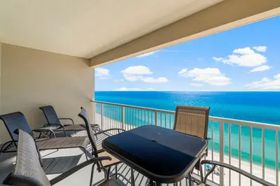 a balcony with chairs and a table and a view of the ocean at Palazzo #505 by InJoy Vacations in Panama City Beach