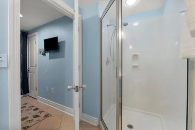 a shower with a glass door in a bathroom at Palazzo #505 by InJoy Vacations in Panama City Beach