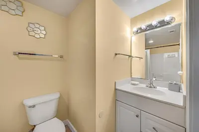 a bathroom with a toilet and a sink at Shores of Panama #1230 by Nautical Properties in Panama City Beach