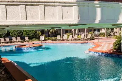 a large swimming pool with chairs in a hotel at Shores of Panama #1230 by Nautical Properties in Panama City Beach
