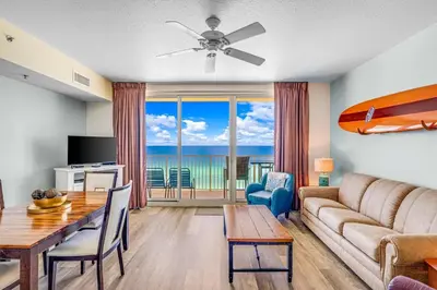 a living room with a couch and a table at Shores of Panama #1230 by Nautical Properties in Panama City Beach