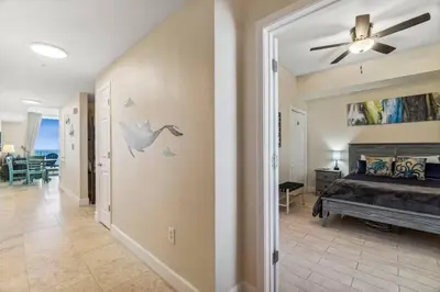 a bedroom with a bed and a ceiling fan at Ocean Front Condo 29th Floor - Must be 25 to Book in Panama City Beach