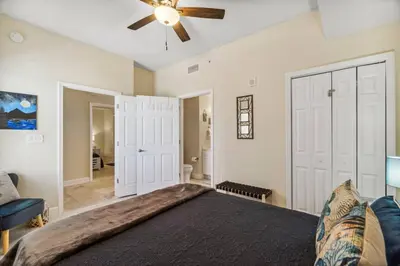 a bedroom with a bed and a ceiling fan at Ocean Front Condo 29th Floor - Must be 25 to Book in Panama City Beach