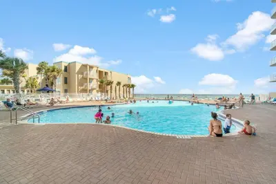 a group of people in a swimming pool at the beach at Ocean Front Condo 29th Floor - Must be 25 to Book in Panama City Beach